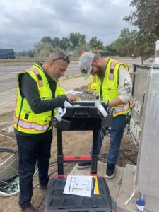 Two people installing a GRIDSMART Intersection detection system using power over fiber"